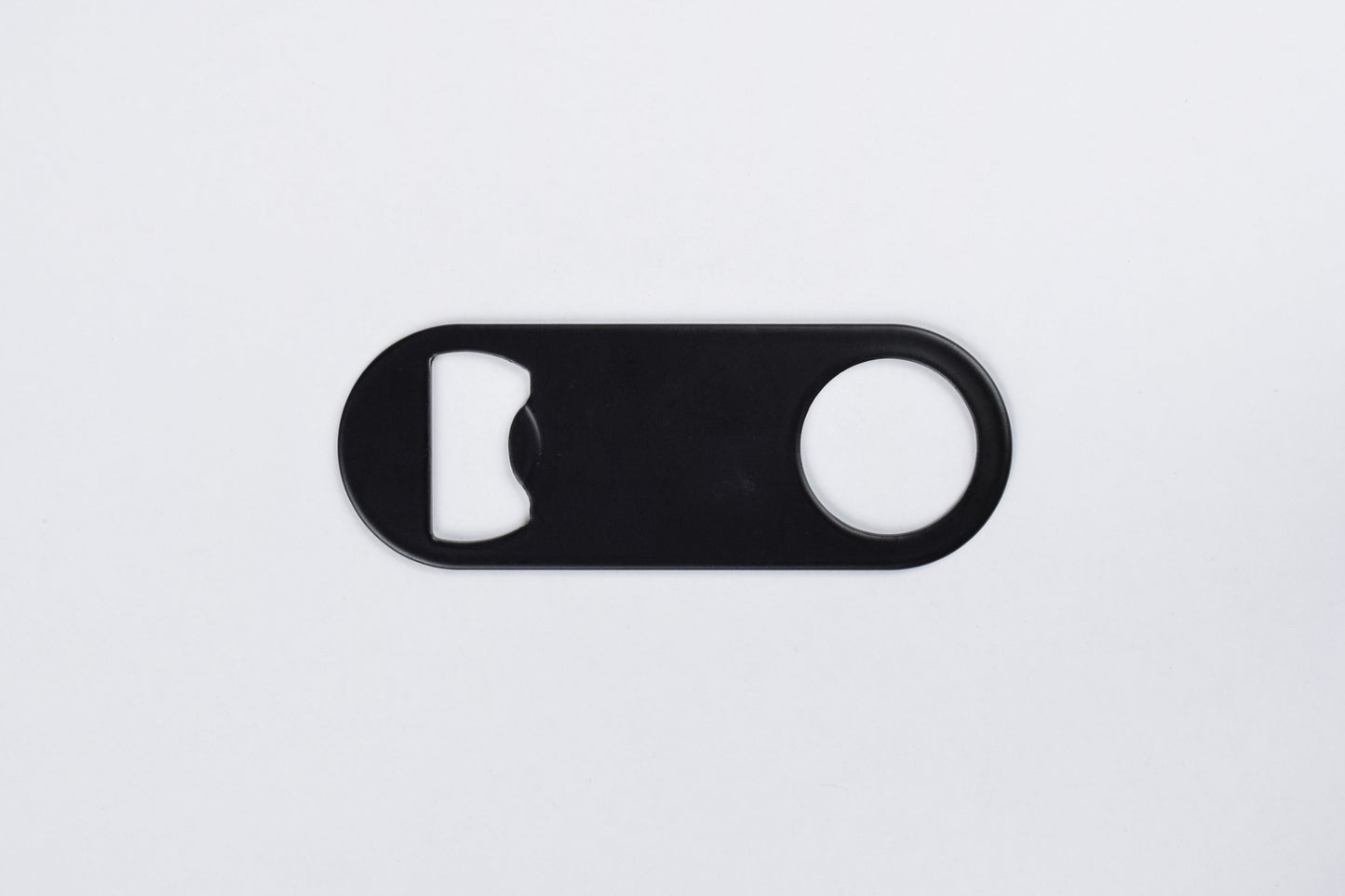 A black stainless steel bottle opener keychain with no key ring, displayed against a white background.