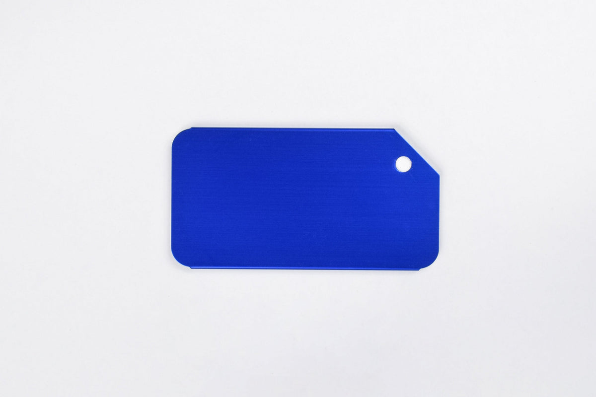A blue aluminum luggage tag on a white background