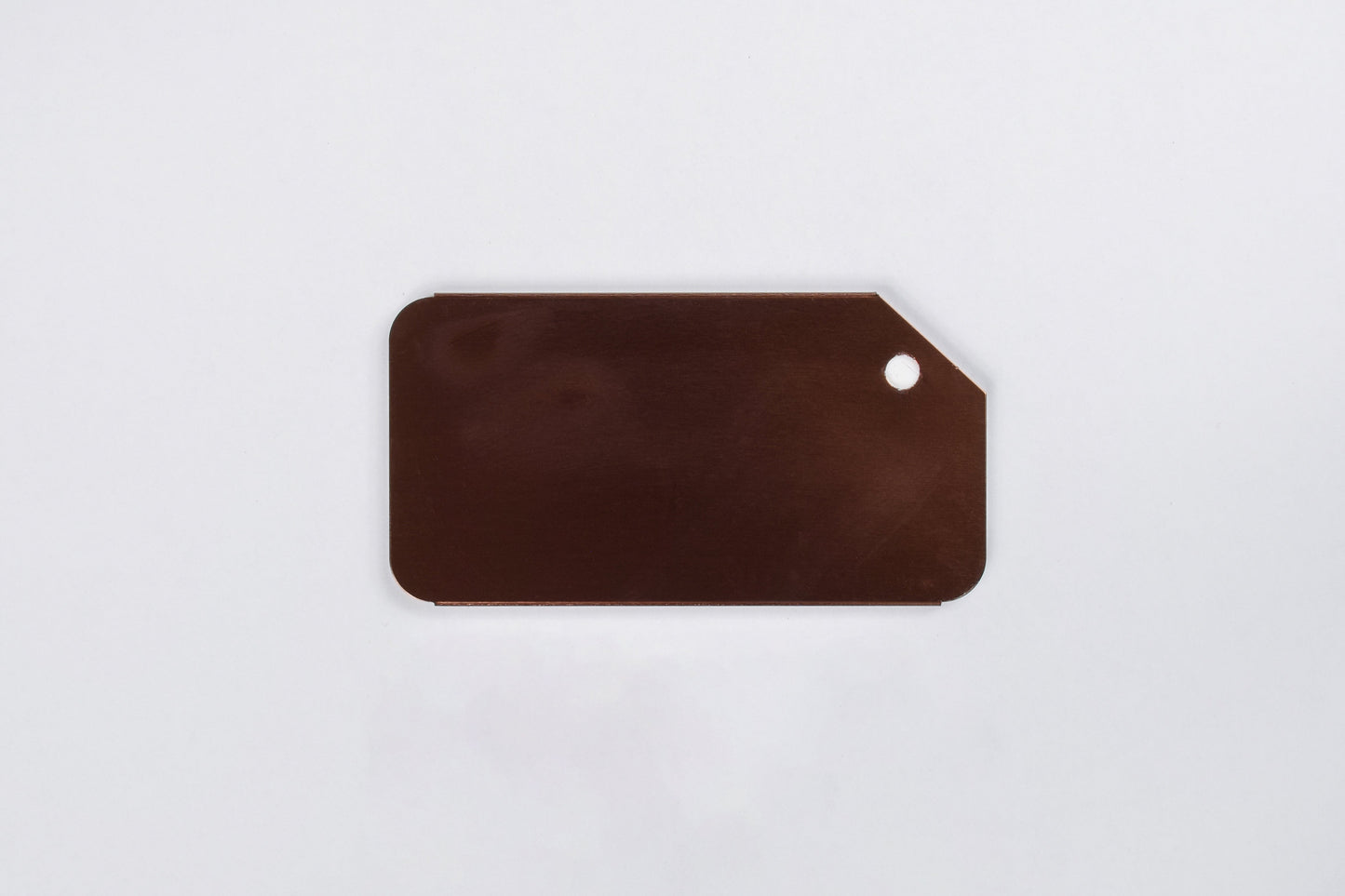 A collection of custom engraved aluminum luggage tags in various colors, each featuring a silver/gray engraved text.