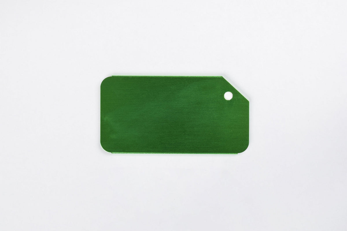 a green aluminum luggage tag on a white background