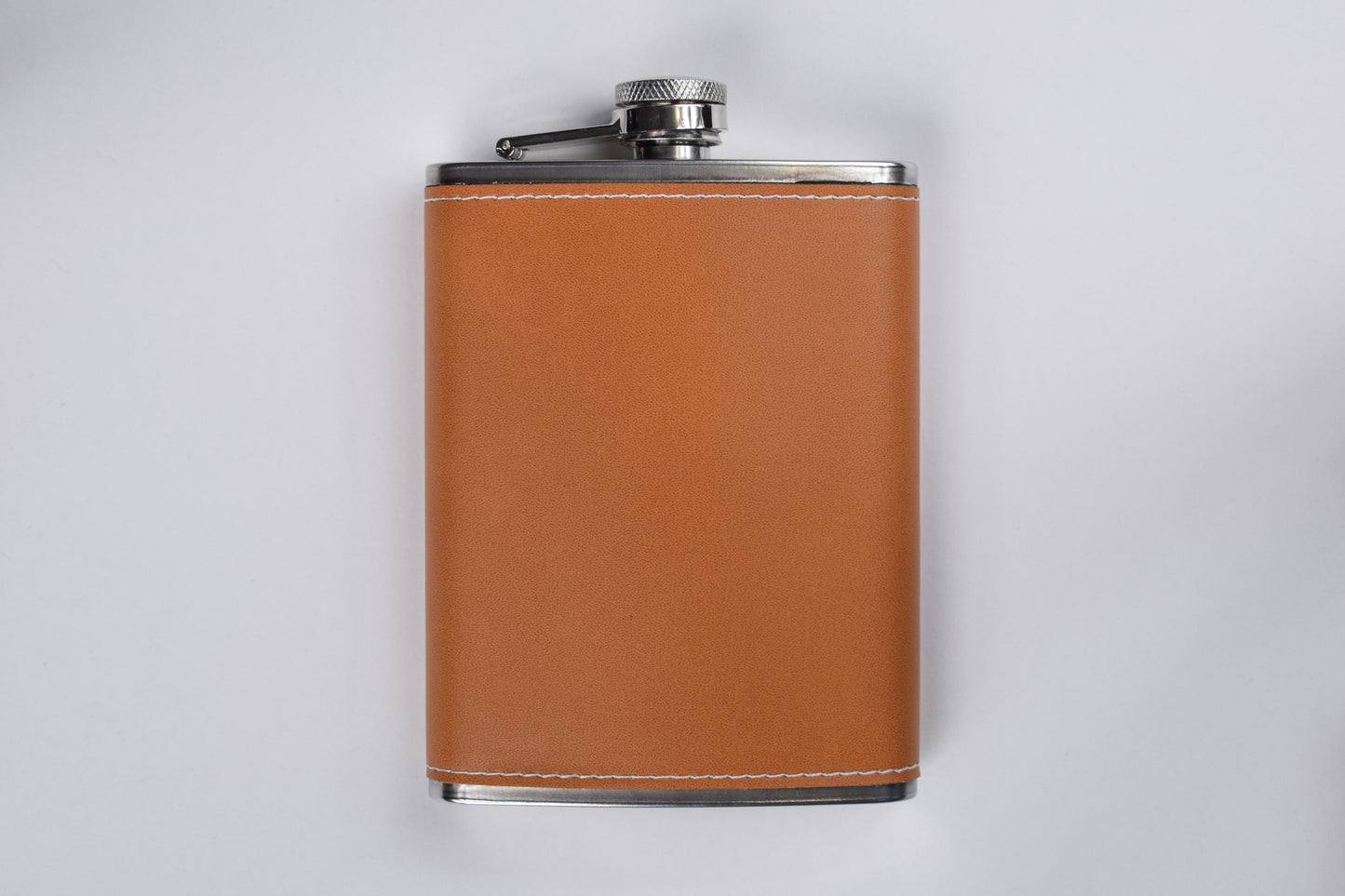 a leather wrapped flask against a white background