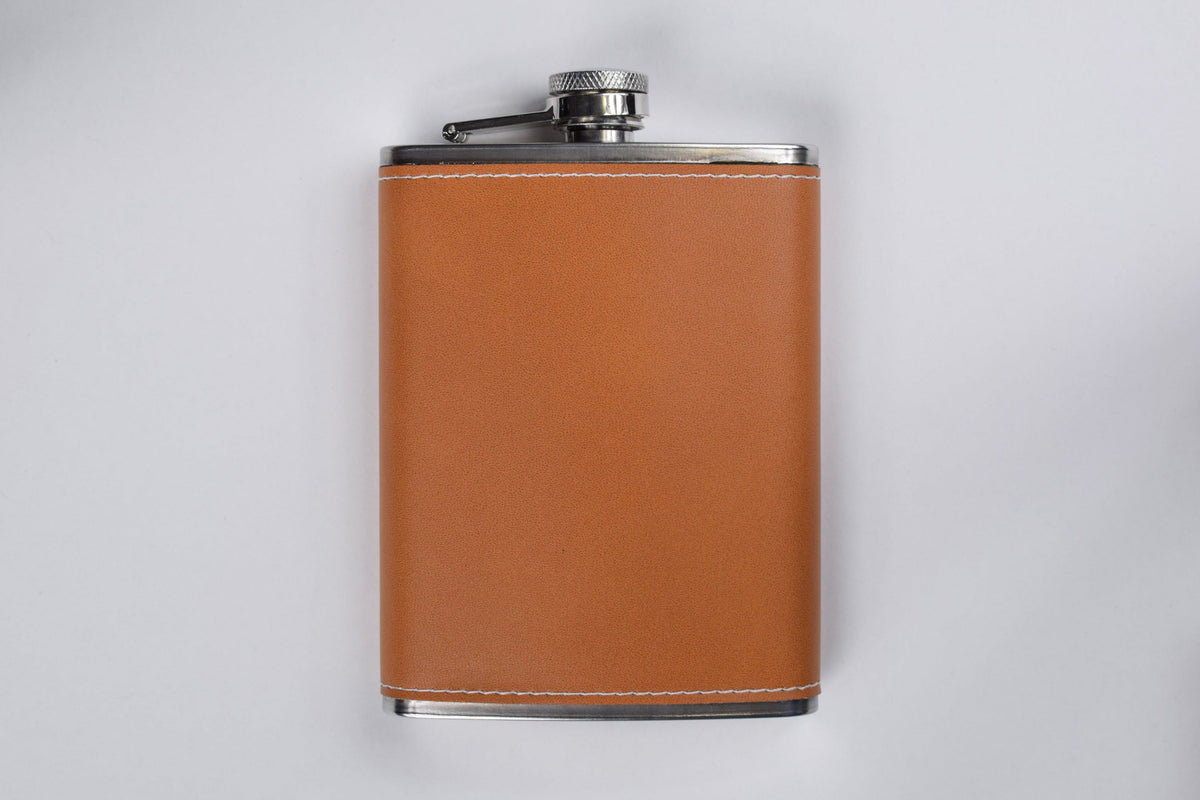 a leather wrapped flask against a white background