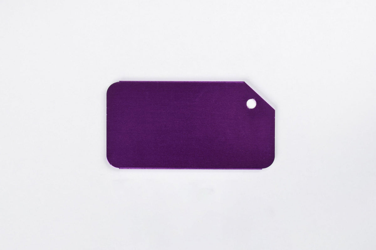 a purple aluminum luggage tag on a white background