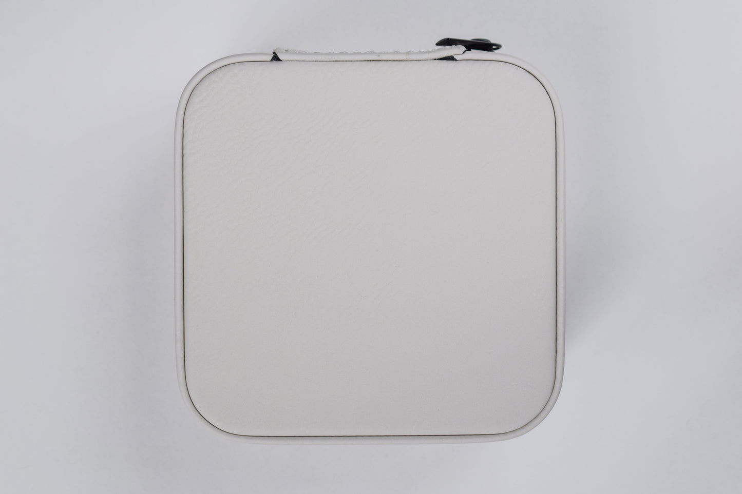 a white synthetic leatherette jewelry box against a white background