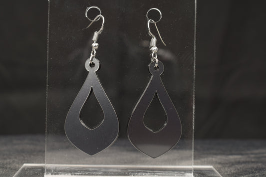 a pair of teardrop shaped hoop style earrings in charcoal metallic acrylic displayed on a clear stand, featuring stainless steel hooks
