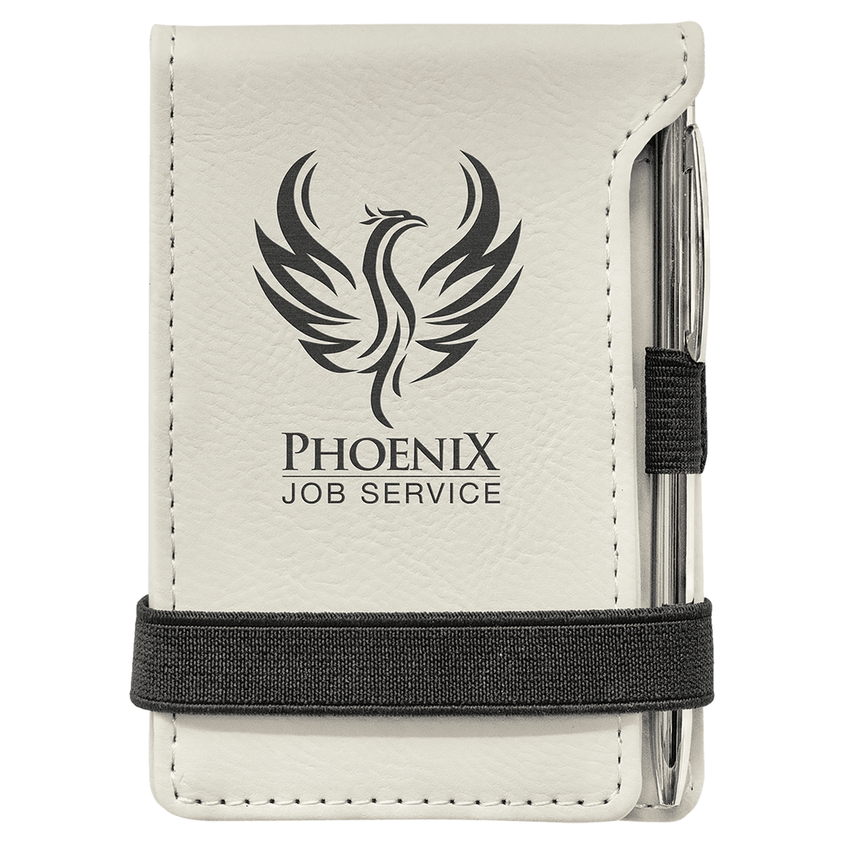 A white mini notepad with a pen, featuring a custom laser engraving of a phoenix on the cover, with a black elastic band for closure.