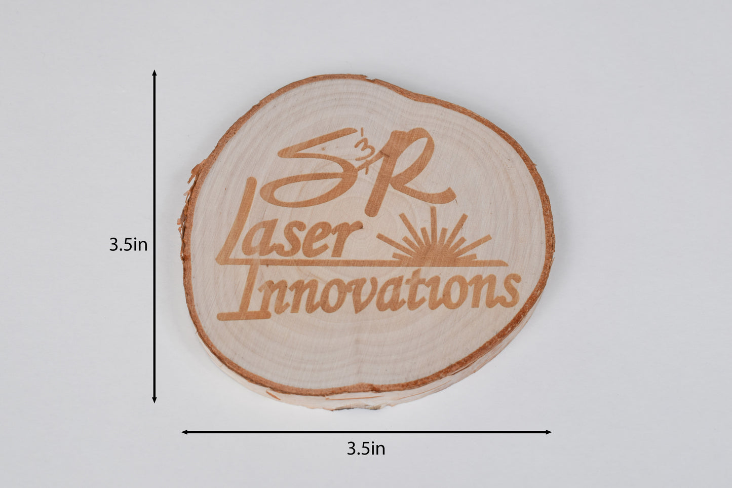 a round birch coaster on a white background with size markers