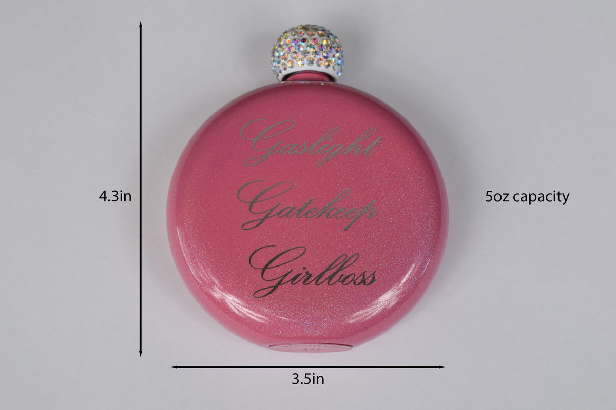 a round pink glittery flask with a rhinestone lid and the words 'Gaslight Gatekeep Girlboss' laser engraved in the center, placed against a white background with size markers