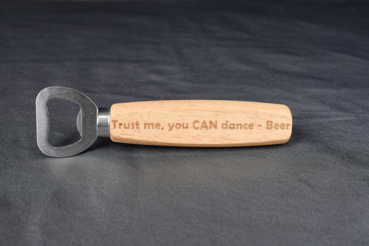 Wooden-handled bottle opener with engraved text on a dark background